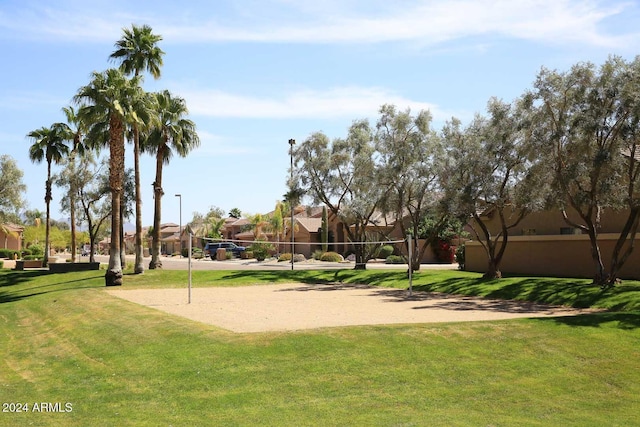 view of property's community featuring volleyball court and a yard