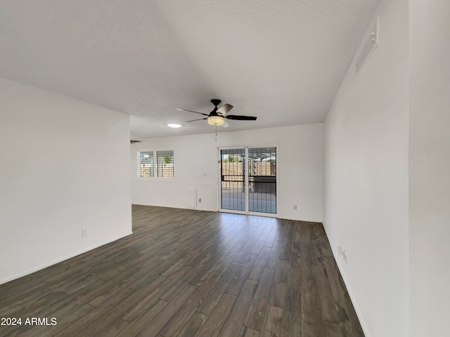 spare room featuring ceiling fan, a textured ceiling, and dark hardwood / wood-style flooring