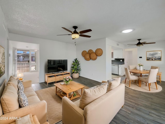 living room with dark hardwood / wood-style floors, a textured ceiling, and ceiling fan