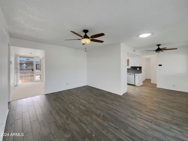 unfurnished living room with a textured ceiling, dark hardwood / wood-style floors, and ceiling fan