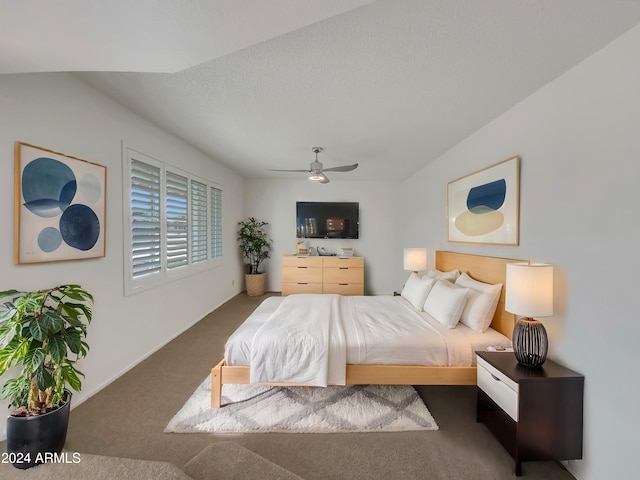 carpeted bedroom with ceiling fan and a textured ceiling