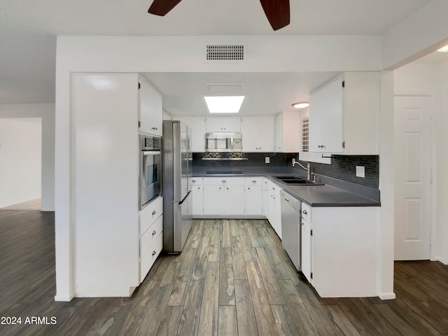 kitchen with white cabinetry, stainless steel appliances, sink, and dark hardwood / wood-style flooring