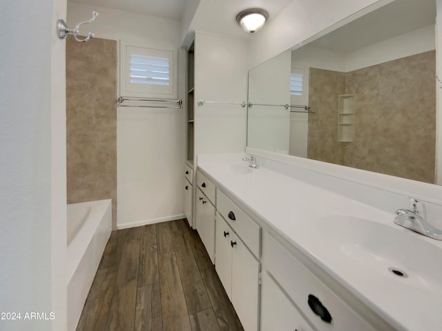 bathroom featuring vanity, washtub / shower combination, and wood-type flooring