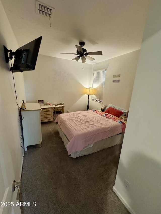 bedroom featuring dark colored carpet, visible vents, and ceiling fan