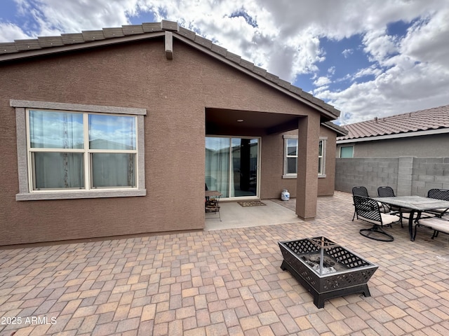 view of patio with a fire pit and fence