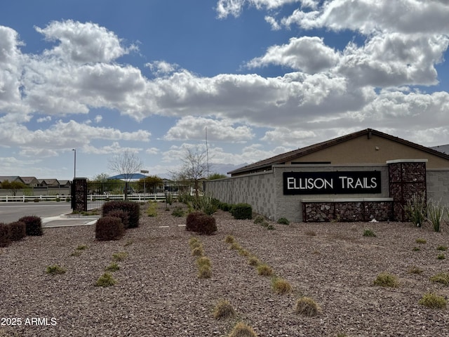 community sign featuring fence