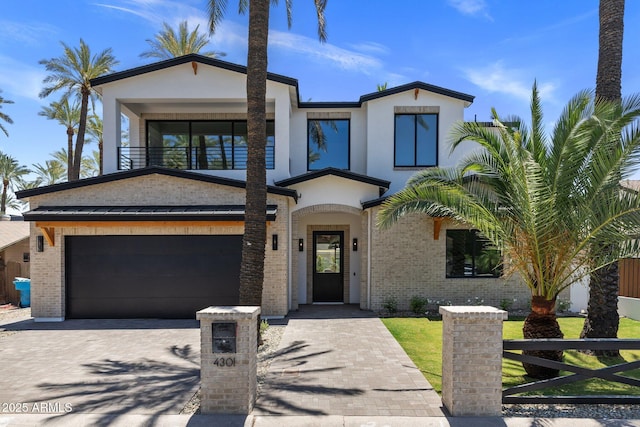 4301 E Sells Dr, Phoenix, AZ 85018 - view of front of house with decorative driveway, brick siding, stucco siding, and a balcony