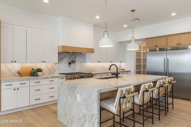 4301 E Sells Dr, Phoenix, AZ 85018 - kitchen featuring built in refrigerator, a sink, light wood-style floors, decorative backsplash, and recessed lighting
