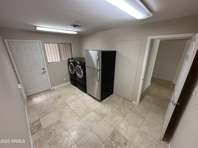 9476 E Laurel Ln, Scottsdale, AZ 85260 - laundry area with separate washer and dryer, baseboards, and a textured ceiling