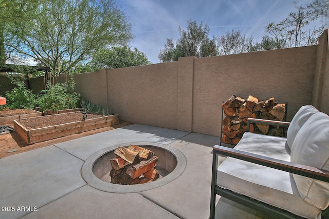 9476 E Laurel Ln, Scottsdale, AZ 85260 - fenced backyard featuring an outdoor fire pit, a vegetable garden, and a patio