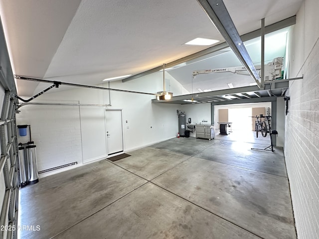 9476 E Laurel Ln, Scottsdale, AZ 85260 - garage featuring a garage door opener, electric water heater, and baseboards