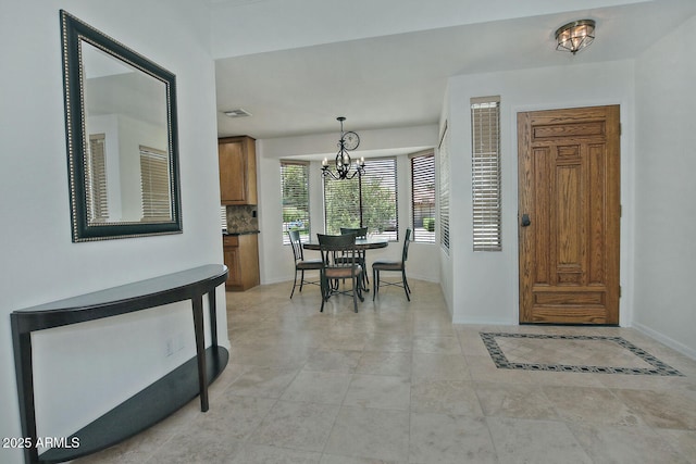 9476 E Laurel Ln, Scottsdale, AZ 85260 - foyer with a chandelier, baseboards, and light tile patterned floors