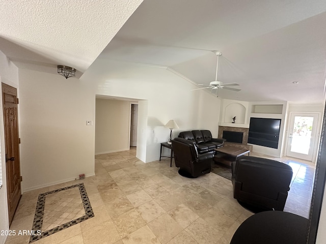 9476 E Laurel Ln, Scottsdale, AZ 85260 - living area with vaulted ceiling, a ceiling fan, a tile fireplace, and baseboards