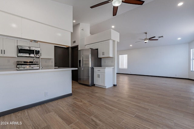 kitchen featuring appliances with stainless steel finishes, white cabinetry, and ceiling fan