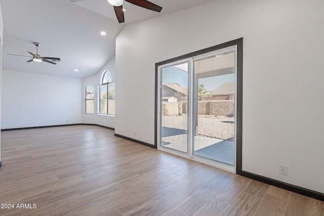 spare room featuring ceiling fan, light hardwood / wood-style flooring, and vaulted ceiling