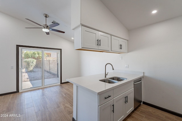 kitchen with white cabinetry, sink, and vaulted ceiling