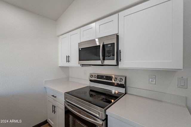 kitchen featuring stainless steel appliances and white cabinetry