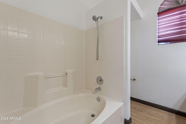 bathroom featuring shower / washtub combination and hardwood / wood-style flooring