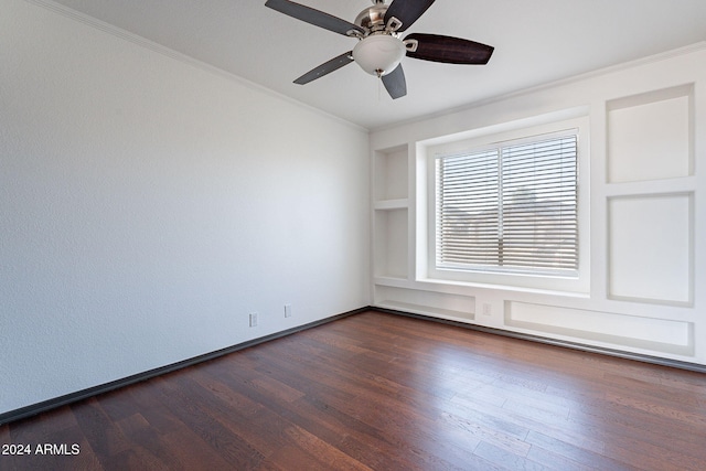 empty room featuring dark hardwood / wood-style flooring, ceiling fan, built in features, and ornamental molding