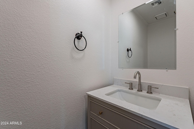 bathroom featuring vanity and ornamental molding