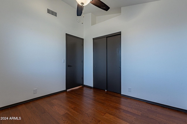 unfurnished bedroom featuring ceiling fan, a closet, and dark hardwood / wood-style floors