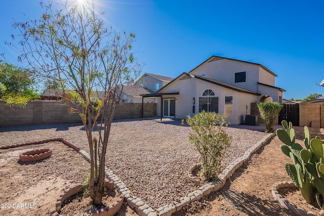 rear view of property featuring central air condition unit and a patio