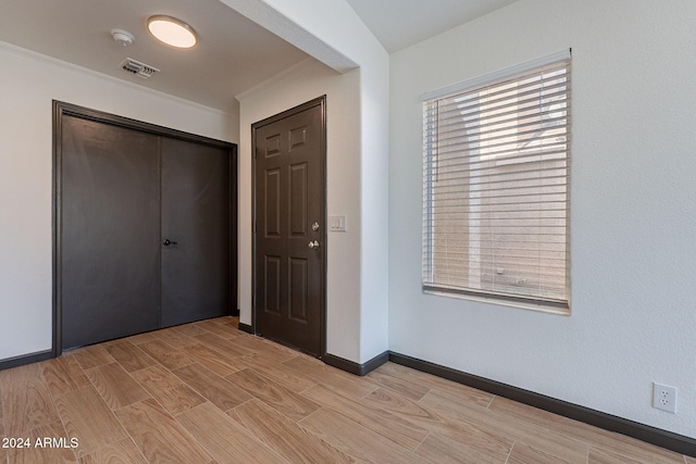 entrance foyer featuring crown molding