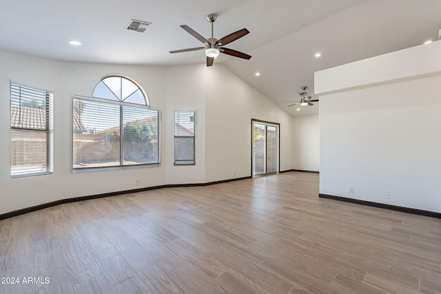 unfurnished room with light wood-type flooring, high vaulted ceiling, and ceiling fan