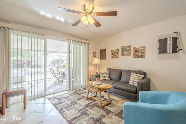 living room with light tile patterned floors, ceiling fan, and vaulted ceiling