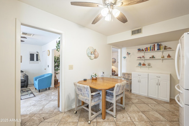 dining space featuring visible vents, ceiling fan, baseboards, and light tile patterned floors