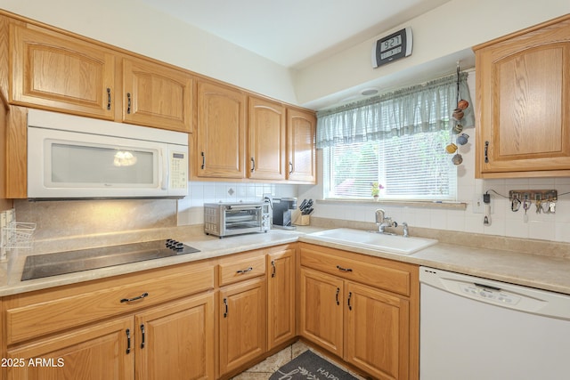 kitchen featuring tasteful backsplash, white appliances, a toaster, and a sink