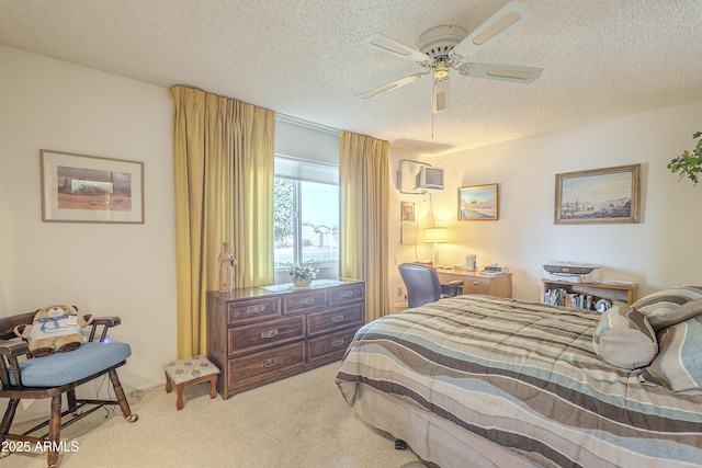 carpeted bedroom featuring ceiling fan and a textured ceiling