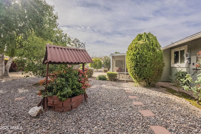 view of yard featuring a sunroom and a patio area