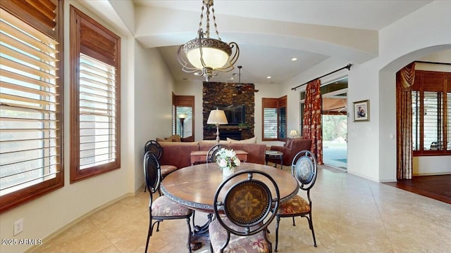 dining room featuring lofted ceiling and light tile patterned floors