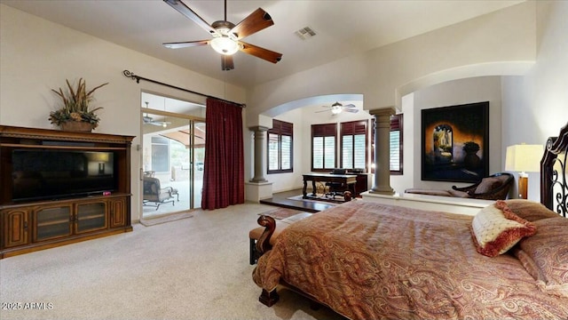 carpeted bedroom with ornate columns, access to outside, and ceiling fan