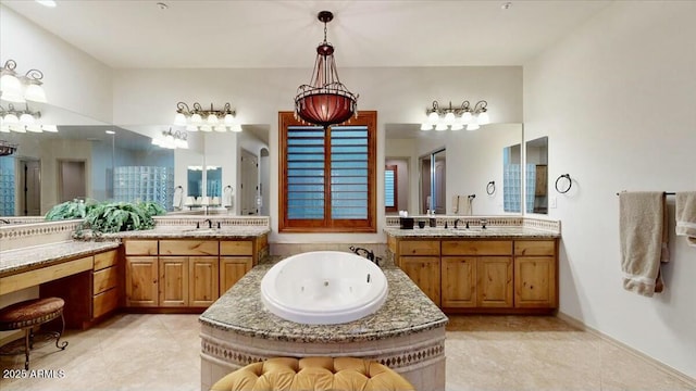 bathroom featuring tile patterned flooring, vanity, and a bathing tub