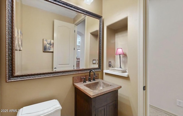 bathroom featuring vanity and toilet