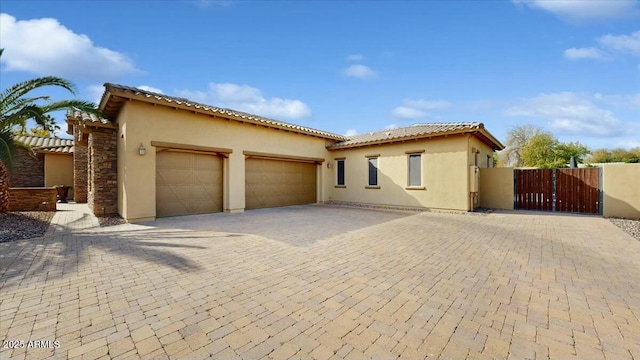 mediterranean / spanish home featuring a garage