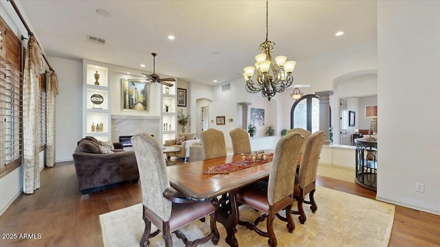 dining space featuring ceiling fan, wood-type flooring, and decorative columns