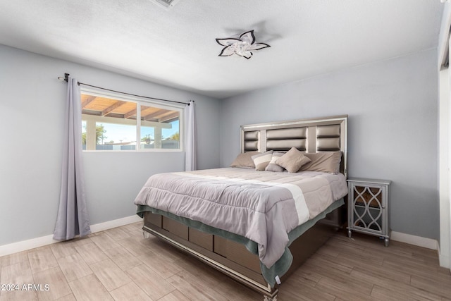 bedroom with hardwood / wood-style flooring