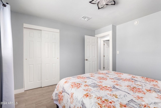 bedroom featuring a closet and light wood-type flooring