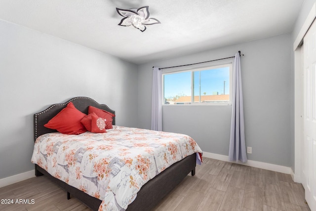 bedroom featuring light hardwood / wood-style flooring and a closet