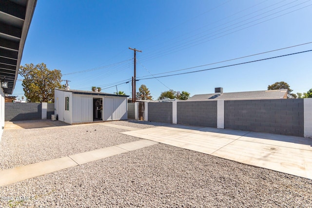 exterior space with a patio and a storage unit