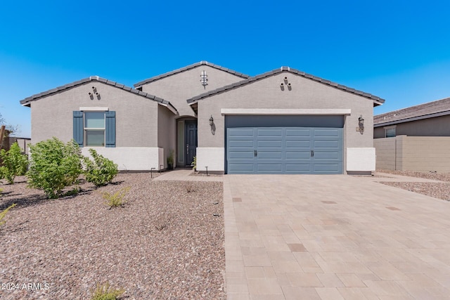 3454 E Jasmine Way, San Tan Valley, AZ 85143 - view of front of home with fence, a tiled roof, stucco siding, decorative driveway, and a garage