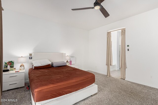 bedroom featuring light carpet and ceiling fan