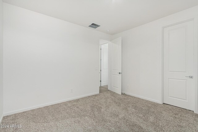 unfurnished bedroom featuring light colored carpet