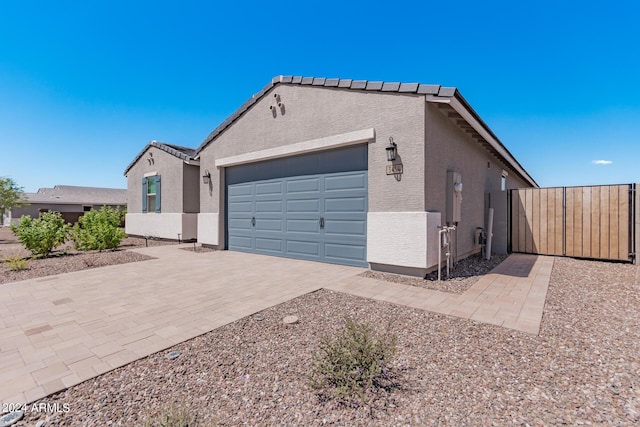 3454 E Jasmine Way, San Tan Valley, AZ 85143 - view of front facade with stucco siding, an attached garage, decorative driveway, and fence