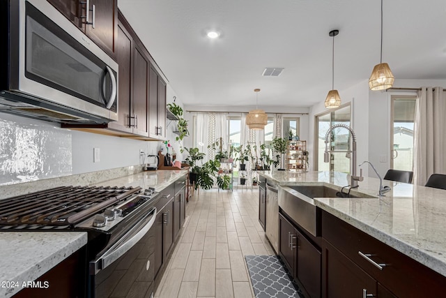 3454 E Jasmine Way, San Tan Valley, AZ 85143 - kitchen with visible vents, dark brown cabinetry, pendant lighting, appliances with stainless steel finishes, and a sink