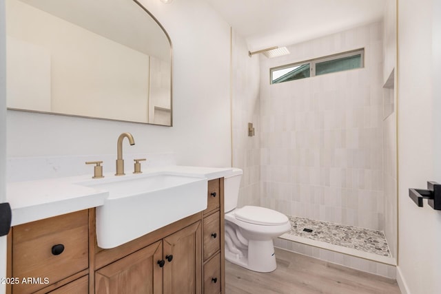 9414 N 50th Dr, Glendale, AZ 85302 - bathroom with vanity, toilet, tiled shower, and wood finished floors
