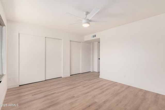 9414 N 50th Dr, Glendale, AZ 85302 - unfurnished bedroom with two closets, light wood finished floors, and ceiling fan